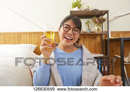 Japanese woman drinking at home remote drinking View Large Photo Image Stock Photo - Japanese woman drinking at home remote drinking. Fotosearch