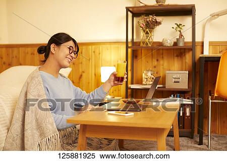 Japanese woman drinking at home remote drinking View Large Photo Image Stock Photography - Japanese woman drinking at home remote drinking. Fotosearch