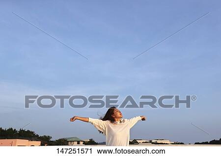 Stock Image - Japanese woman outside. Fotosearch