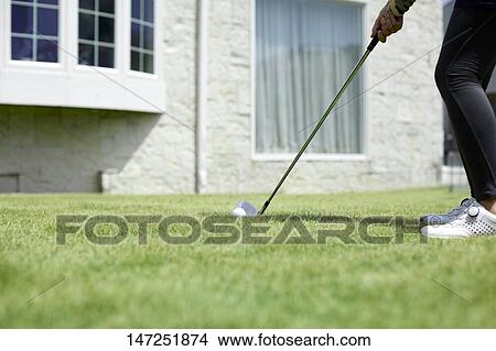 Japanese woman practicing golf in the garden View Large Photo Image Picture - Japanese woman practicing golf in the garden. Fotosearch