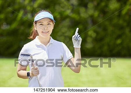 Japanese woman practicing golf in the garden View Large Photo Image Picture - Japanese woman practicing golf in the garden. Fotosearch