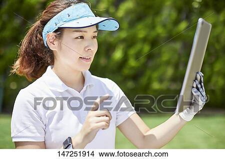 Japanese woman practicing golf in the garden View Large Photo Image Picture - Japanese woman practicing golf in the garden. Fotosearch