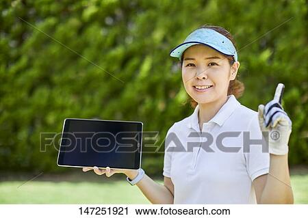 Japanese woman practicing golf in the garden View Large Photo Image Stock Image - Japanese woman practicing golf in the garden. Fotosearch
