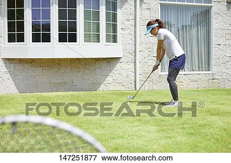 Japanese woman practicing golf in the garden View Large Photo Image Stock Photo - Japanese woman practicing golf in the garden. Fotosearch