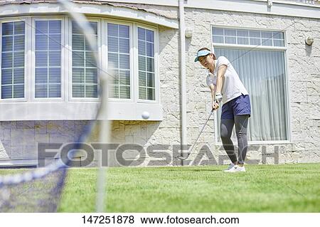 Japanese woman practicing golf in the garden View Large Photo Image Stock Photo - Japanese woman practicing golf in the garden. Fotosearch