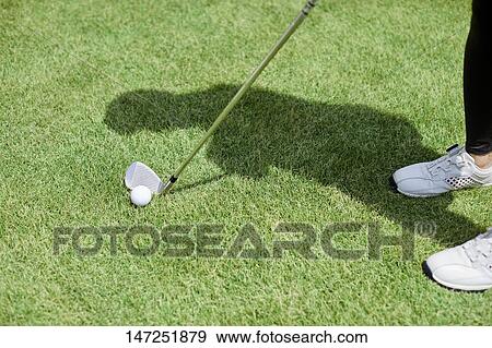 Stock Photo - Japanese woman practicing golf in the garden. Fotosearch