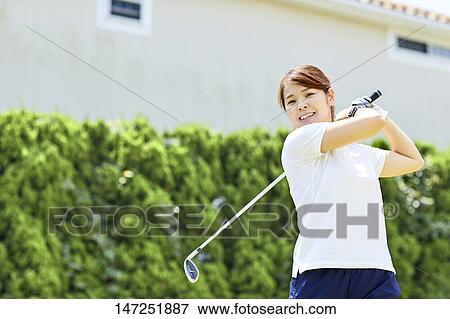 Japanese woman practicing golf in the garden View Large Photo Image Stock Photo - Japanese woman practicing golf in the garden. Fotosearch