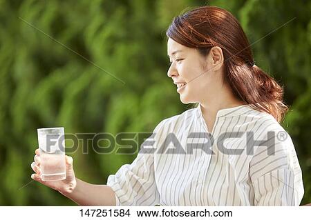 Japanese woman relaxing in the garden View Large Photo Image Picture - Japanese woman relaxing in the garden. Fotosearch