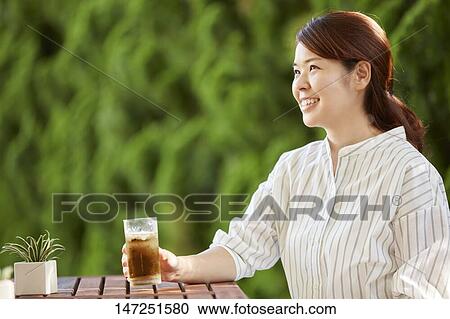 Japanese woman relaxing in the garden View Large Photo Image Stock Image - Japanese woman relaxing in the garden. Fotosearch