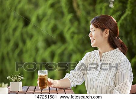 Japanese woman relaxing in the garden View Large Photo Image Stock Image - Japanese woman relaxing in the garden. Fotosearch