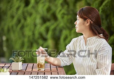 Japanese woman relaxing in the garden View Large Photo Image Stock Image - Japanese woman relaxing in the garden. Fotosearch