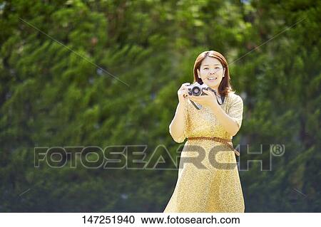 Japanese woman relaxing in the garden View Large Photo Image Stock Image - Japanese woman relaxing in the garden. Fotosearch
