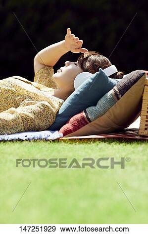Japanese woman relaxing in the garden View Large Photo Image Stock Photo - Japanese woman relaxing in the garden. Fotosearch