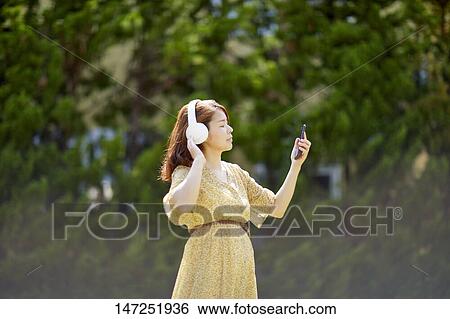 Japanese woman relaxing in the garden View Large Photo Image Stock Photograph - Japanese woman relaxing in the garden. Fotosearch