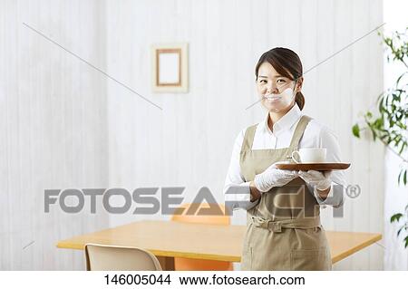 Picture - Japanese woman wearing face shield. Fotosearch