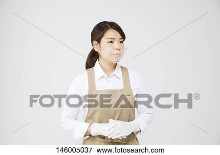 Stock Photo - Japanese woman wearing face shield. Fotosearch