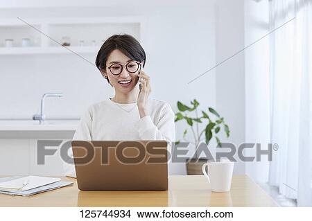 Japanese woman working from home View Large Photo Image Picture - Japanese woman working from home. Fotosearch