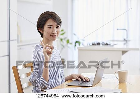 Japanese woman working from home View Large Photo Image Picture - Japanese woman working from home. Fotosearch
