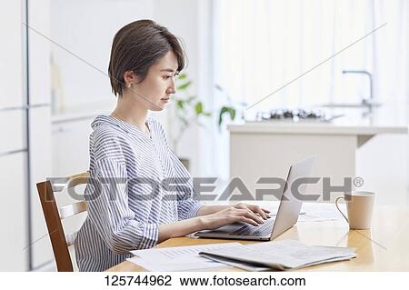 Japanese woman working from home View Large Photo Image Stock Image - Japanese woman working from home. Fotosearch