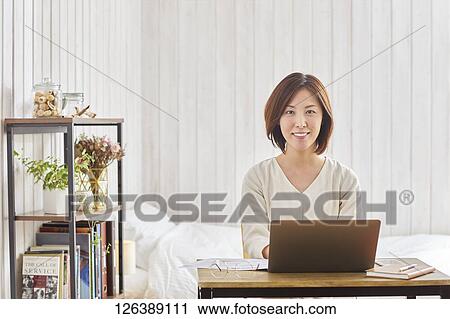 Japanese woman working from home View Large Photo Image Stock Image - Japanese woman working from home. Fotosearch