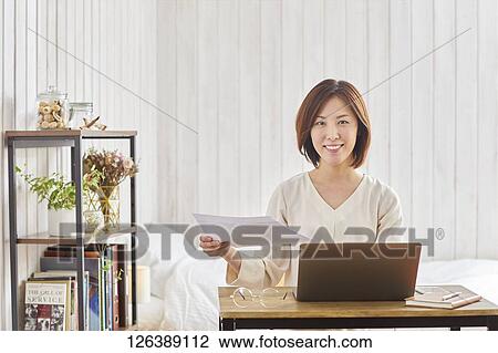 Japanese woman working from home View Large Photo Image Stock Image - Japanese woman working from home. Fotosearch