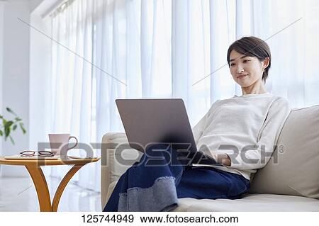 Japanese woman working from home View Large Photo Image Stock Photo - Japanese woman working from home. Fotosearch