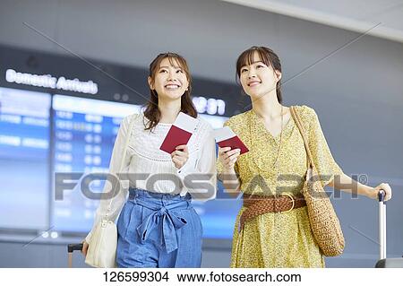 Picture - Japanese women at the airport. Fotosearch
