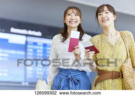 Stock Image - Japanese women at the airport. Fotosearch