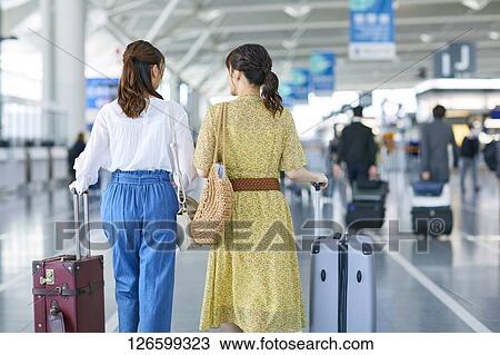 Stock Image - Japanese women at the airport. Fotosearch
