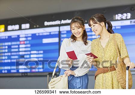 Stock Image - Japanese women at the airport. Fotosearch
