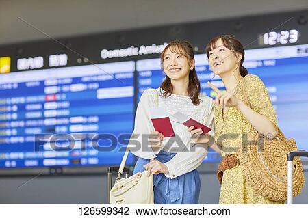 Stock Image - Japanese women at the airport. Fotosearch