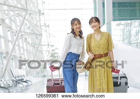 Stock Image - Japanese women at the airport. Fotosearch
