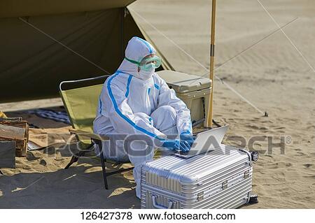 Man in a hazmat suit at the beach View Large Photo Image Stock Photo - Man in a hazmat suit at the beach. Fotosearch