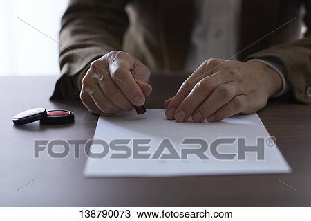 Stock Image - Man Putting Seal. Fotosearch