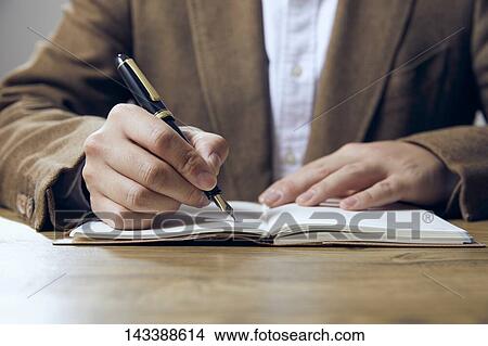 Man writing on paper View Large Photo Image Picture - Man writing on paper. Fotosearch