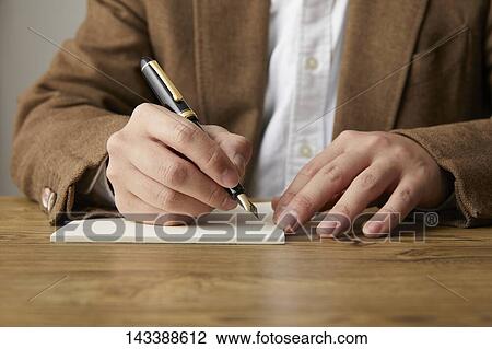 Man writing on paper View Large Photo Image Stock Image - Man writing on paper. Fotosearch