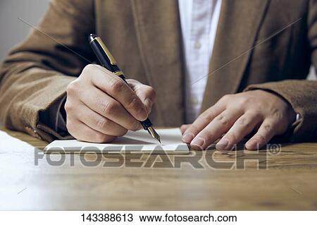 Man writing on paper View Large Photo Image Stock Image - Man writing on paper. Fotosearch