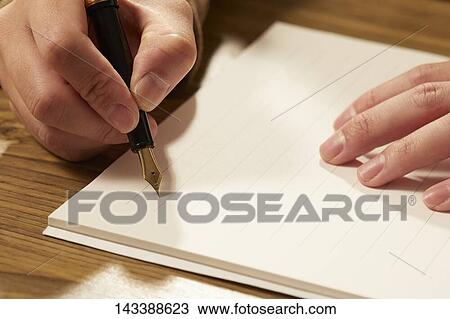 Stock Image - Man writing on paper. Fotosearch