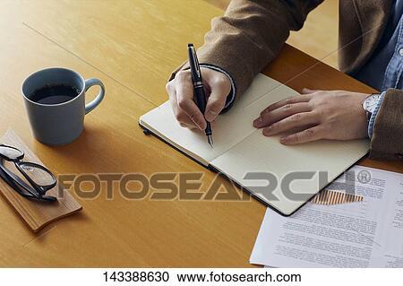 Stock Image - Man writing on paper. Fotosearch