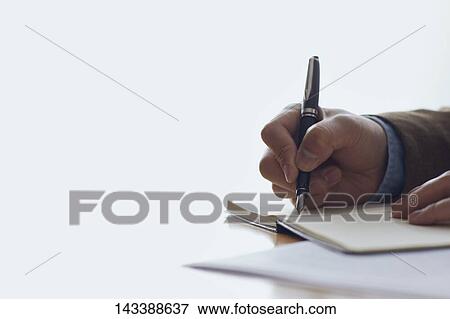 Stock Photo - Man writing on paper. Fotosearch