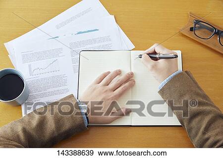 Stock Photo - Man writing on paper. Fotosearch