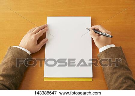 Stock Photo - Man writing on paper. Fotosearch