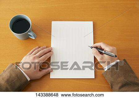Stock Photo - Man writing on paper. Fotosearch