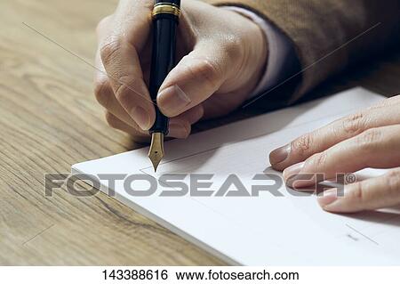 Man writing on paper View Large Photo Image Stock Photograph - Man writing on paper. Fotosearch