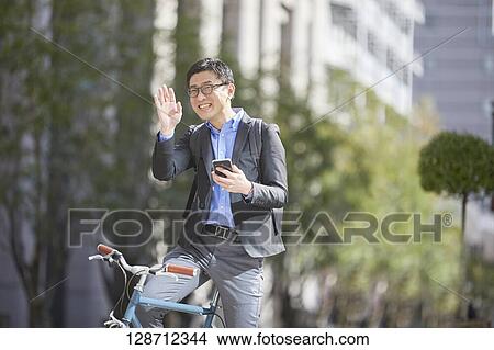 Middle Aged Japanese Businessman Riding A Bicycle View Large Photo Image Picture - Middle Aged Japanese Businessman Riding A Bicycle. Fotosearch