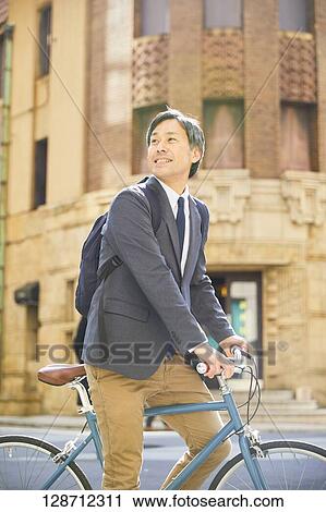Middle Aged Japanese Businessman Riding A Bicycle View Large Photo Image Stock Image - Middle Aged Japanese Businessman Riding A Bicycle. Fotosearch