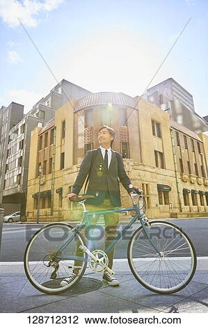 Middle Aged Japanese Businessman Riding A Bicycle View Large Photo Image Stock Image - Middle Aged Japanese Businessman Riding A Bicycle. Fotosearch