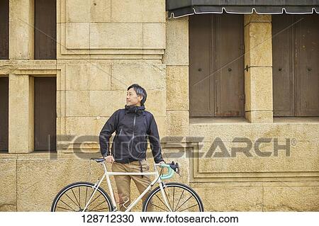 Middle Aged Japanese Businessman Riding A Bicycle View Large Photo Image Stock Image - Middle Aged Japanese Businessman Riding A Bicycle. Fotosearch