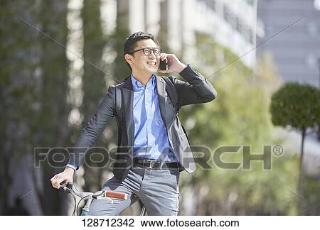 Middle Aged Japanese Businessman Riding A Bicycle View Large Photo Image Stock Image - Middle Aged Japanese Businessman Riding A Bicycle. Fotosearch