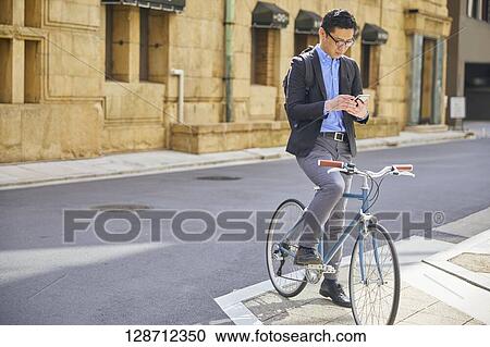 Stock Image - Middle Aged Japanese Businessman Riding A Bicycle. Fotosearch